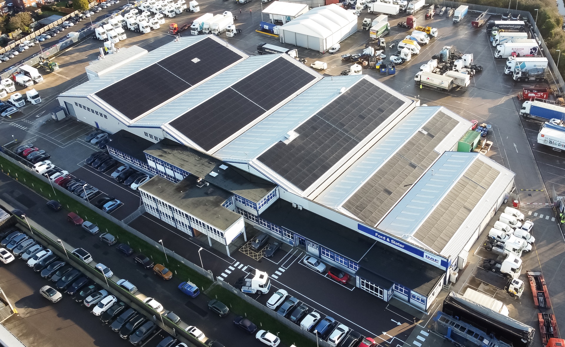 Drone shot of a building's roof showing its solar panels.